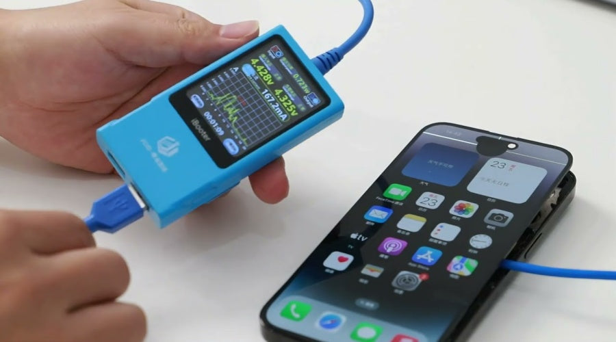 Hand holding a USB tester measuring charging voltage on a smartphone for phone repair.