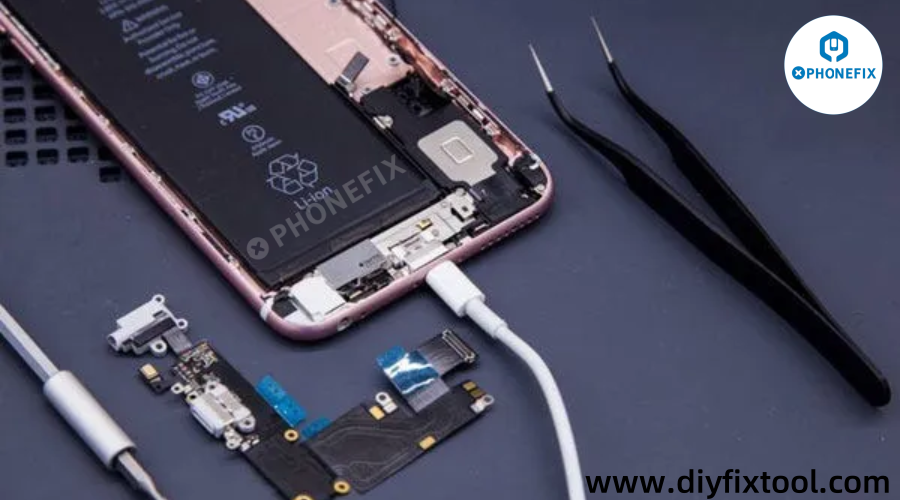 Open smartphone with battery and circuit board exposed, repair tools and tweezers nearby