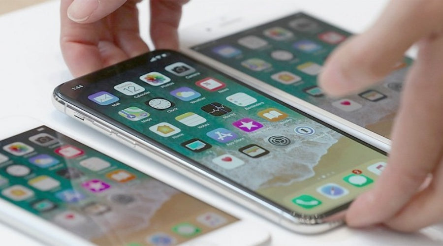 Hands testing multiple smartphones with touchscreens, mobile phone repair and diagnostics
