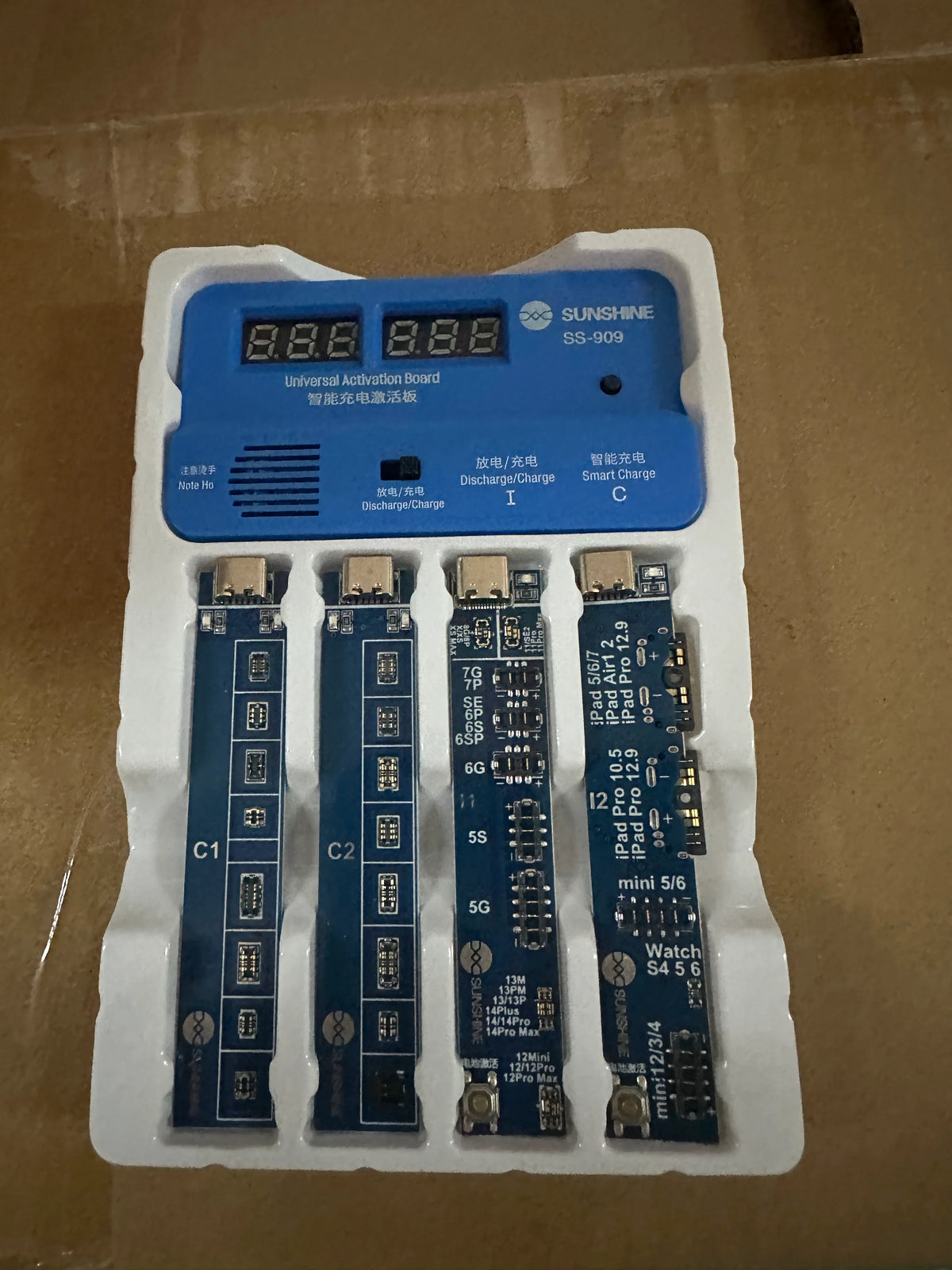 PHONEFIX SS-909 universal battery charging activation board tester for phone repair, showing the compact battery tester tool with connectors.
