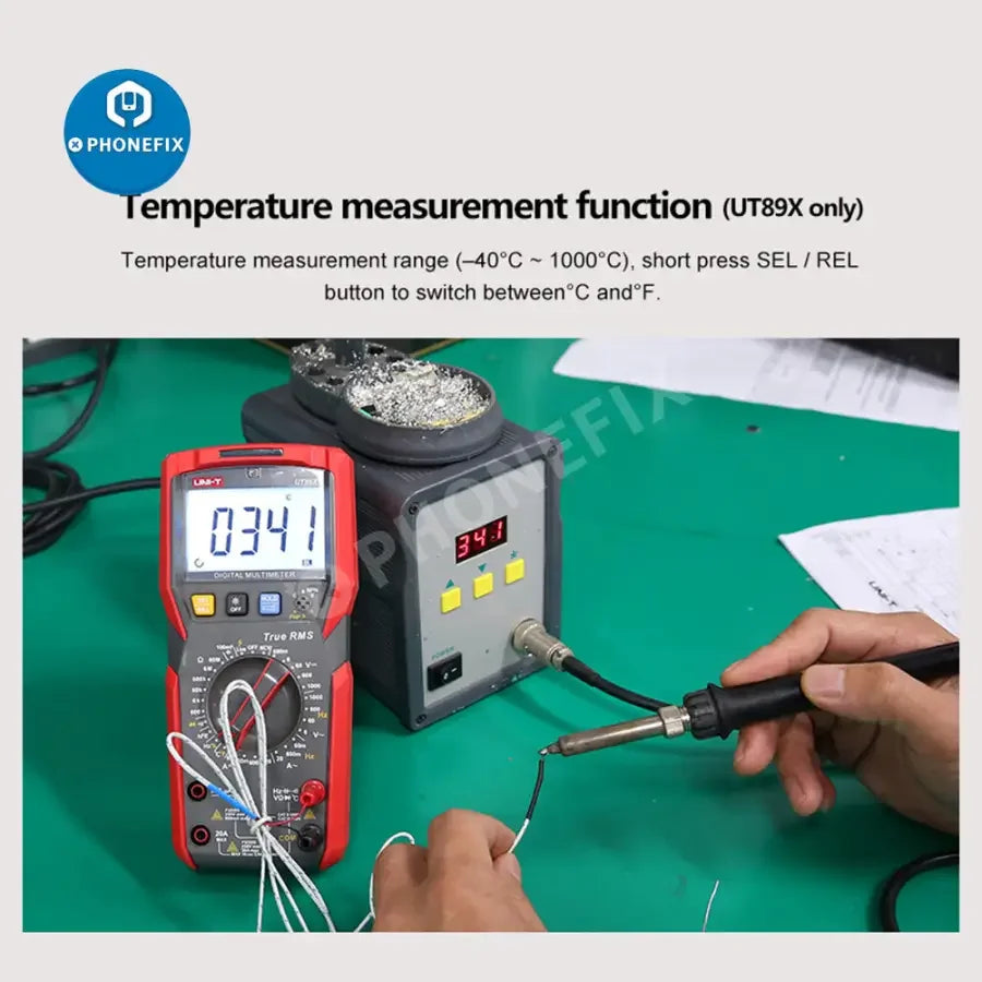 PhoneFix UT89XD LED digital multimeter showing capacitance, voltage, and current measurement display with test leads attached.