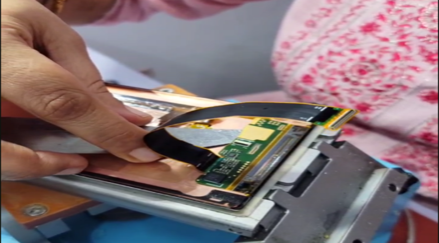 Technician repairing smartphone screen with specialized tools and flex cable connector