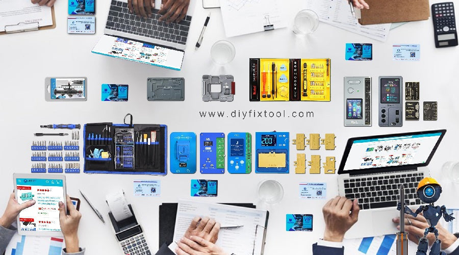 Assorted mobile phone repair tools and diagnostic kits arranged on a white office desk with laptops and paperwork.