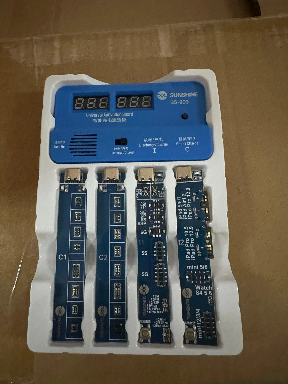 PhoneFix iPhone battery charging activation board tester with power cable, used for testing and activating iPhone battery circuits.