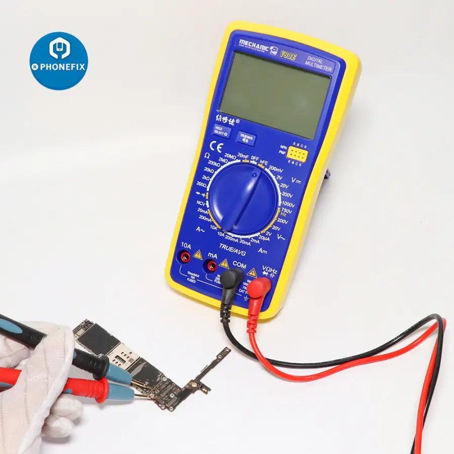 PHONEFIX Mechanic V90E digital multimeter with automatic display, showing colorful readings and measurement probes in use.