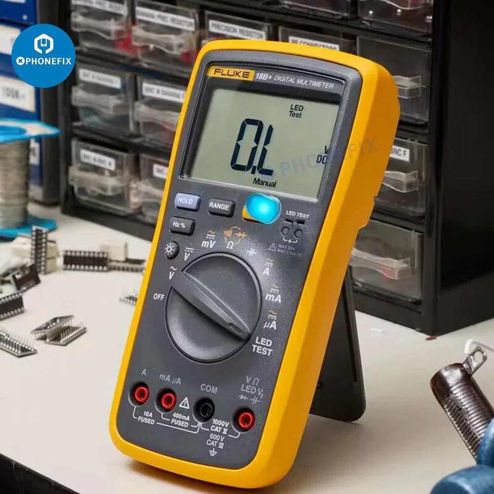 Fluke 15B+ 17B+ 18B+ digital multimeter with voltage and frequency testing, branded by PHONEFIX, showing display and measurement dial.