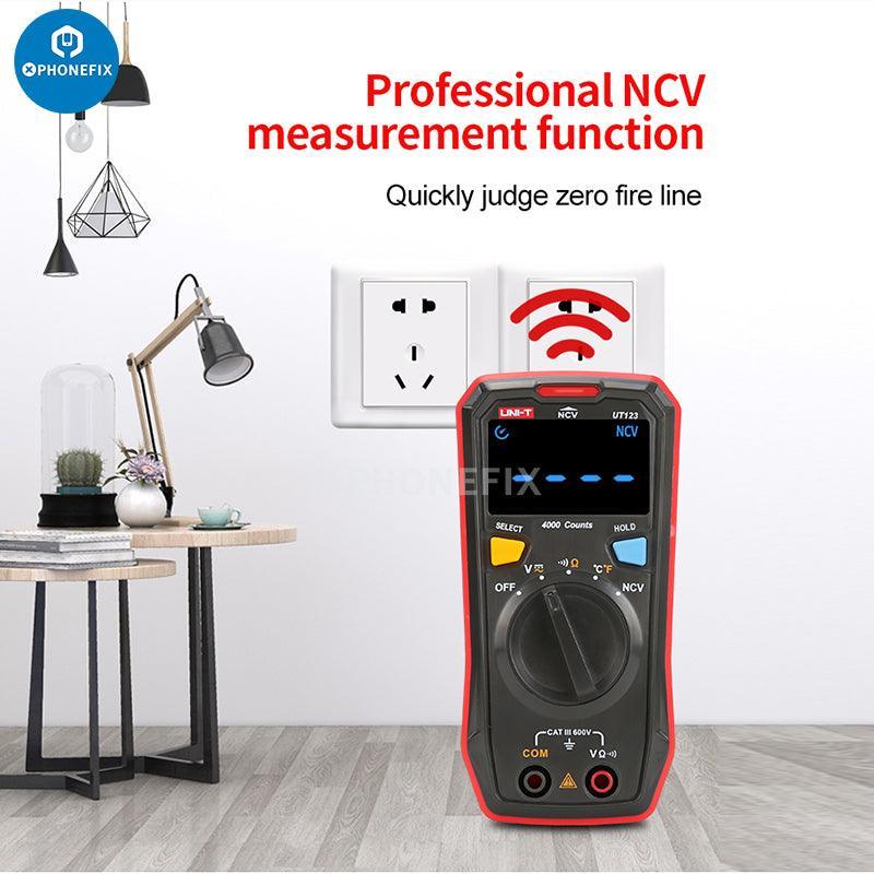 Phonefix UNI-T UT123D digital multimeter displaying AC/DC voltage readings, with probes and digital screen visible.