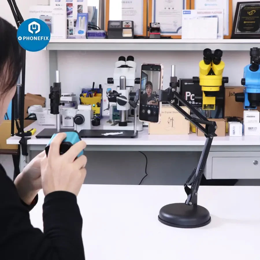 Overhead PhoneFix live streaming camera stand with articulating arm for studio shooting, holding a phone securely in place.