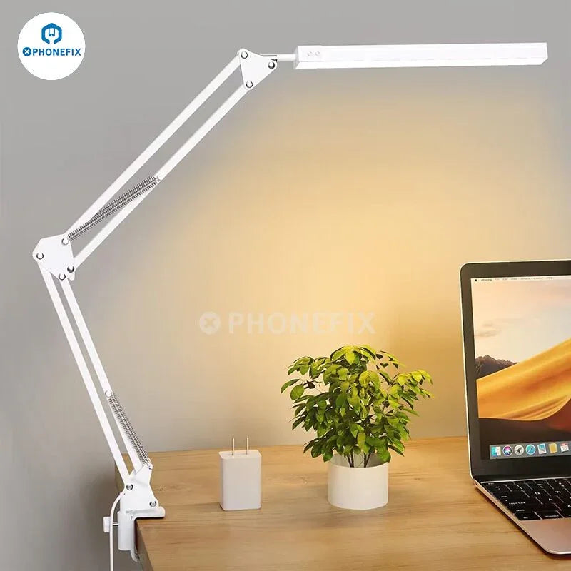 PhoneFIX LED eye protection desk lamp with magnifying glass, metal swing arm, black aluminum clip-on design, ideal for detailed tasks.