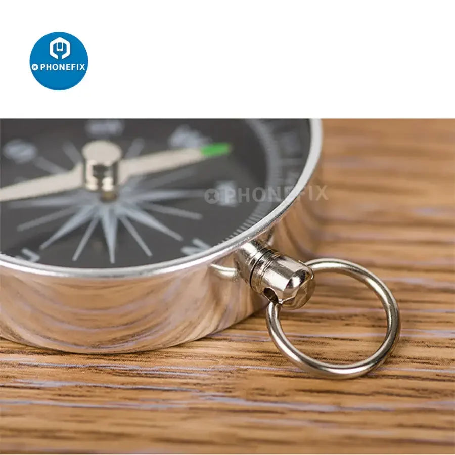Portable lightweight emergency compass by PHONEFIX for outdoor navigation and wild survival assistance.