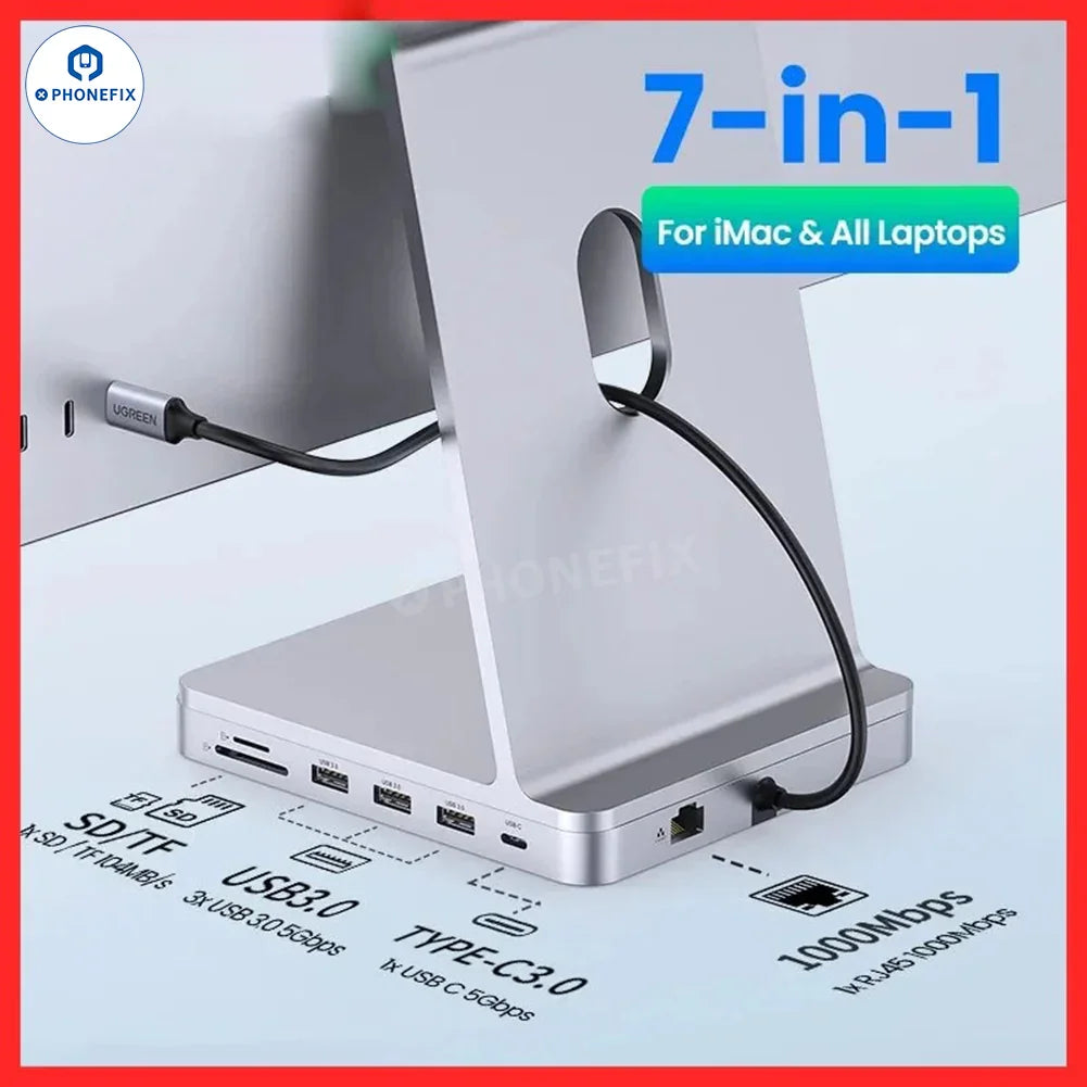 PhoneFIX UGREEN 7-in-1 USB C hub with SD/TF card slots and USB charging port connected to iMac in a workspace setup.