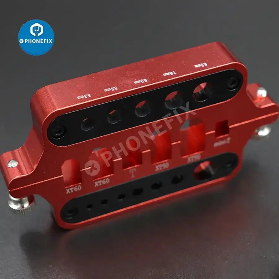 Red PHONEFIX multi-function XT60/90 T plug connector soldering tool holder for RC cars and drones, with various repair tools visible.