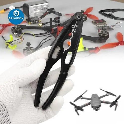 Multi-function RC drone repair tools by PHONEFIX, shock absorber clamp and pliers for RC model drone maintenance.