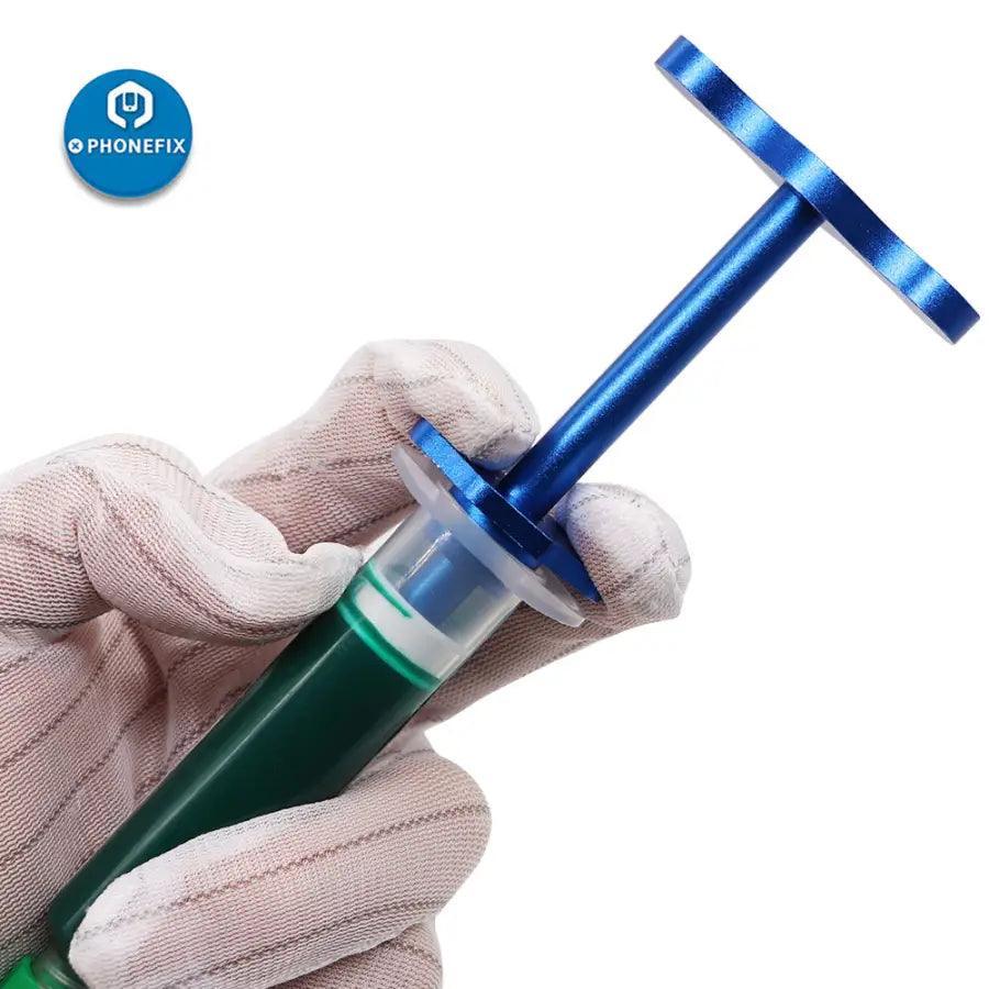 Black metal flux dispenser plunger with three needles, repair assist tool by PHONEFIX for precise flux application.