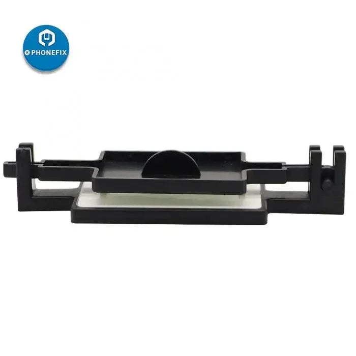 PhoneFIX fixed holder bracket for phone screen protector film cover, used as a screen repair tool attachment.