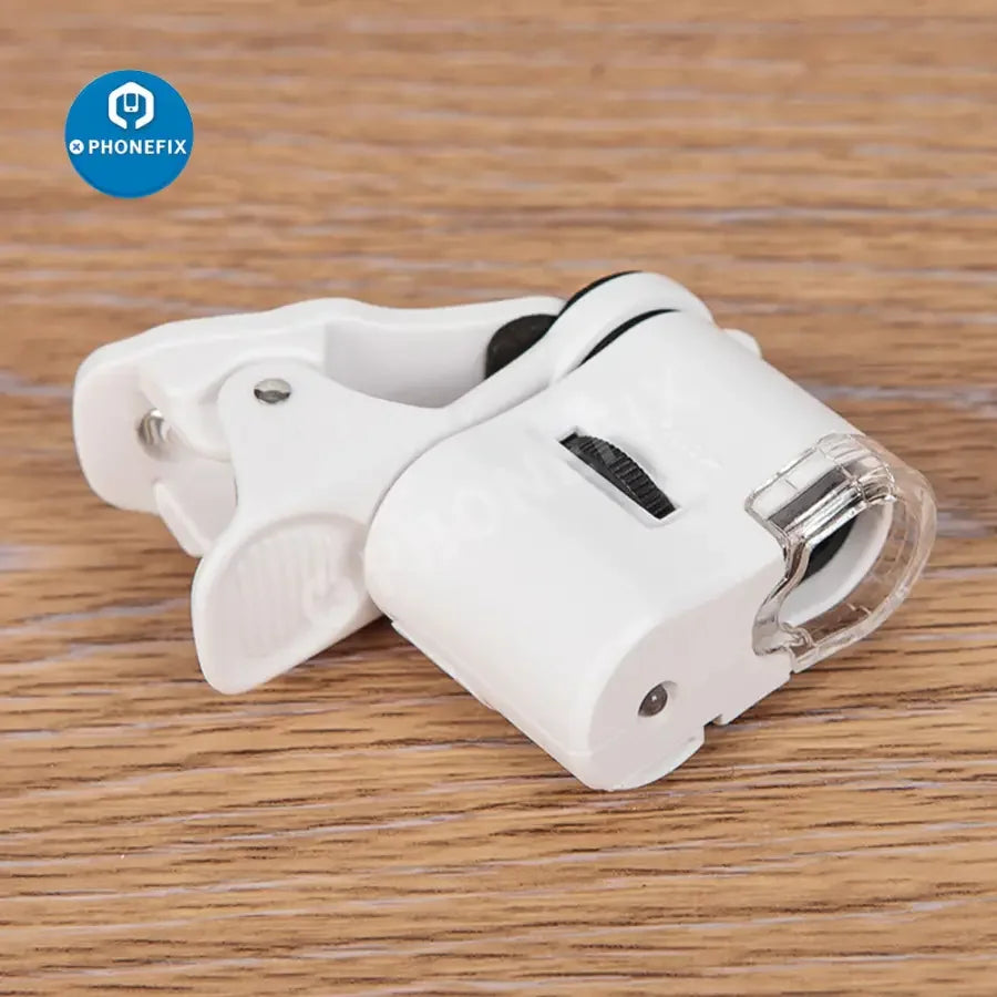 PHONEFIX 60X portable clip-on soldering magnifying glass with LED light, focusing for detailed electronic work.
