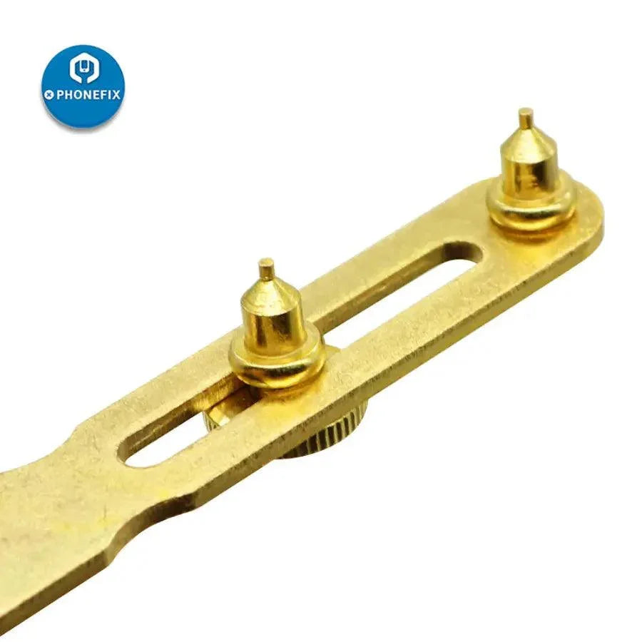 Gold two-claw screw watch back case opener tool by PHONEFIX, used for watchmaker repairs and opening watch cases.